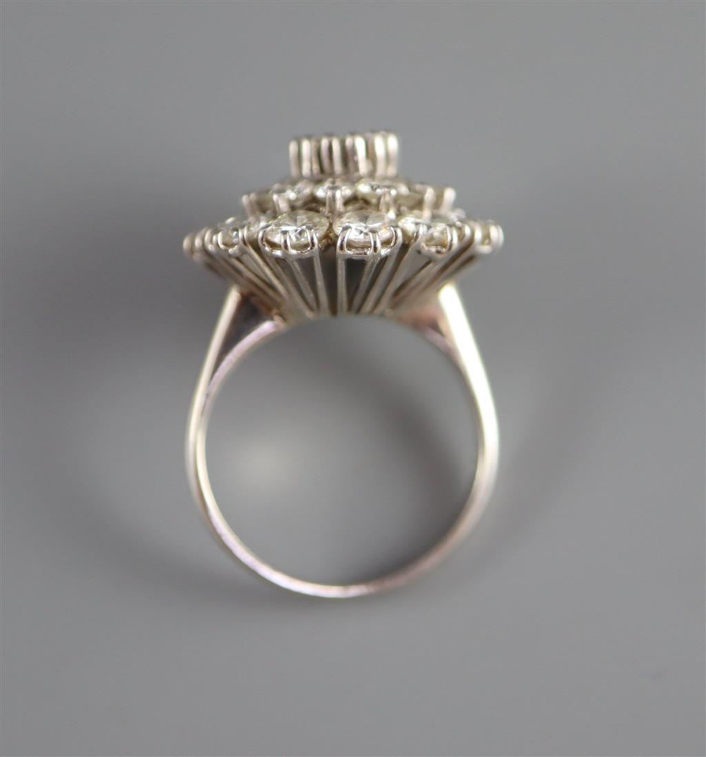 A modern 14ct white gold and diamond cluster ring,